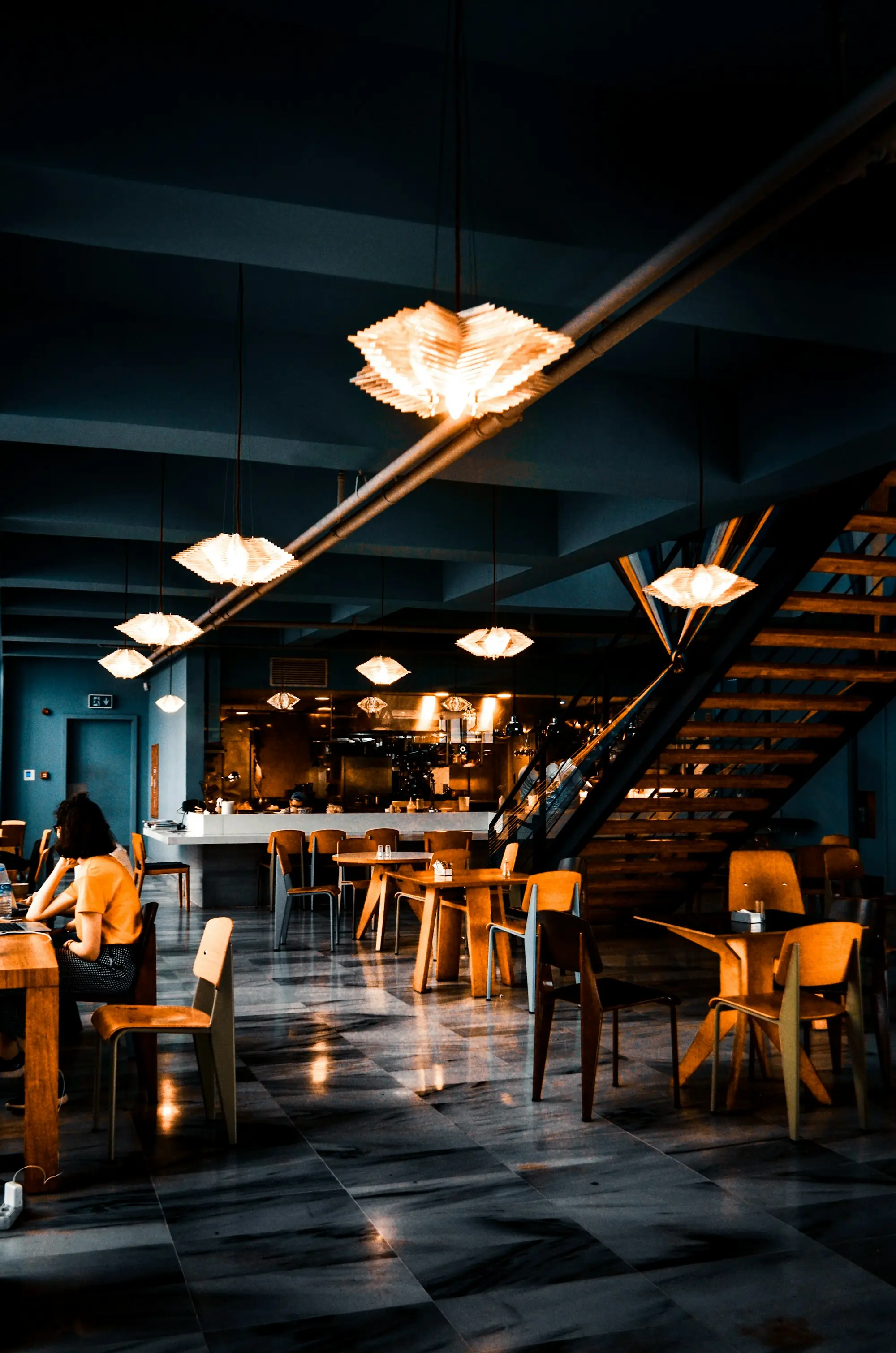 A softly lit dining room at Canto, tables set for evening service
